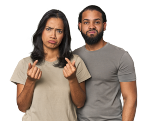 Young Latino couple in studio showing that she has no money.