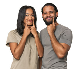 Young Latino couple in studio doubting between two options.