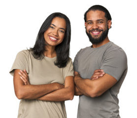 Young Latino couple in studio who feels confident, crossing arms with determination.