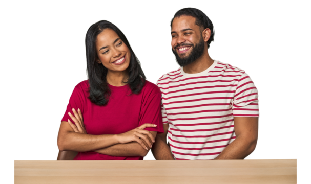 Seated young Latino couple at table smiling confident with crossed arms.