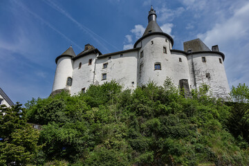 View of Clervaux Castle (Chateau de Clervaux) in Clervaux in Northern Luxembourg, dates back to XII century. Castle stands at a height of 365 meters on a rocky spur above town. Clervaux, Luxembourg.