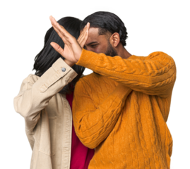 Young Latino couple in studio keeping two arms crossed, denial concept.