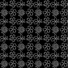 Seamless texture in the form of a white floral pattern in doodle style on a black background