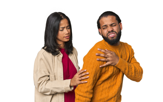 Young Latino couple in studio having a shoulder pain.