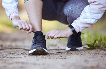 Woman, tie laces and fitness in outdoor, getting ready and prepare for exercise or workout on...