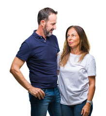 Fototapeta premium Middle age hispanic casual couple over isolated background with serious expression on face. Simple and natural looking at the camera.