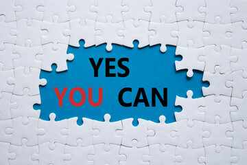 Yes You Can symbol. Concept word Yes You Can on white puzzle. Beautiful blue background. Business and Yes You Can concept. Copy space.