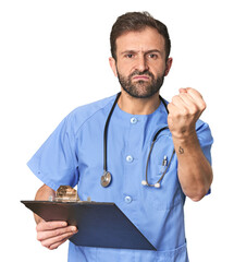 Hispanic male nurse with inventory showing fist to camera, aggressive facial expression.