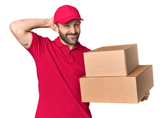 Hispanic male courier with boxes touching back of head, thinking and making a choice.