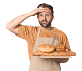 Hispanic male baker with bread tray being shocked, she has remembered important meeting.