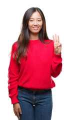 Young asian woman wearing winter sweater over isolated background showing and pointing up with fingers number three while smiling confident and happy.