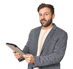 Hispanic male businessman with tablet in studio