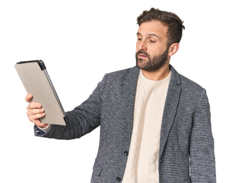 Hispanic male businessman with tablet in studio