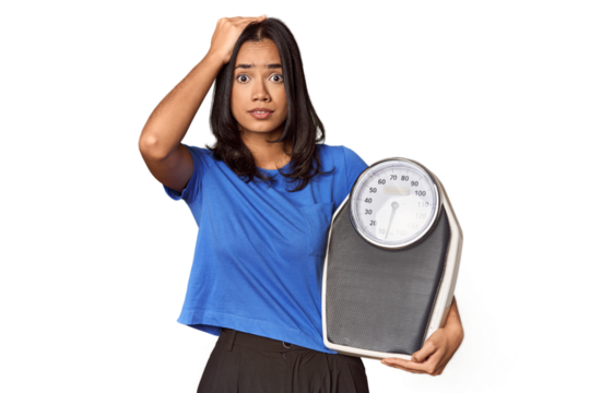 Filipino woman with scale in studio being shocked, she has remembered important meeting.