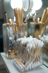 Ear sticks in stand on makeup artist table in beauty salon