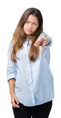 Young beautiful brunette business woman over isolated background looking unhappy and angry showing rejection and negative with thumbs down gesture. Bad expression.