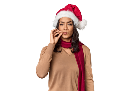 Filipino in Christmas attire and Santa hat with fingers on lips keeping a secret. - Powered by Adobe