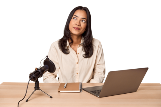 Woman records podcast with laptop dreaming of achieving goals and purposes