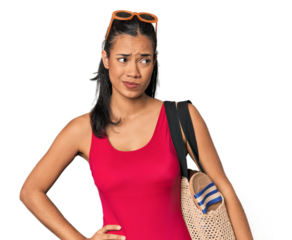 Young Filipina with beach bag confused, feels doubtful and unsure.