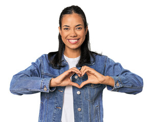 Young Filipina woman smiling and showing a heart shape with hands.