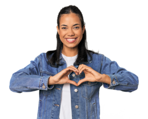 Young Filipina woman smiling and showing a heart shape with hands.