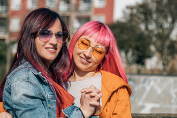 couple of loving lesbian women hugging on the street