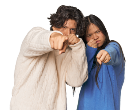 Young interracial couple in studio throwing a punch, anger, fighting due to an argument, boxing.