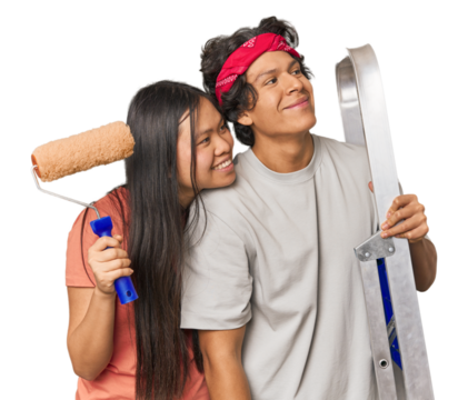 Multiracial couple ready to paint their new home in studio