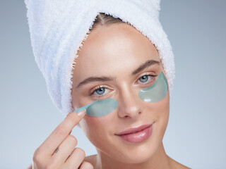 Woman, eyes and remove patches in studio portrait, facial treatment and hydration on blue...