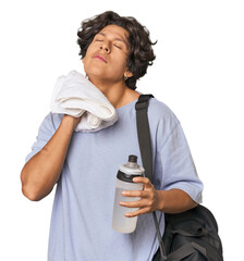 Young Latino athlete wiping sweat in studio