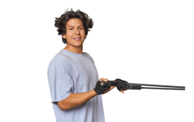 Young Latino man exercising with resistance bands in studio