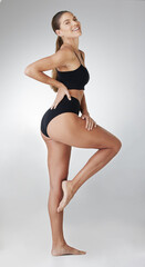 Fototapeta premium Skincare, underwear and legs of woman portrait in studio for dermatology, cosmetics or glow on white background. Wellness, body and model with panties for cosmetology, beauty treatment or liposuction