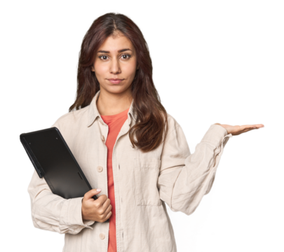 Middle Eastern woman with graphic tablet showing a copy space on a palm and holding another hand on waist.