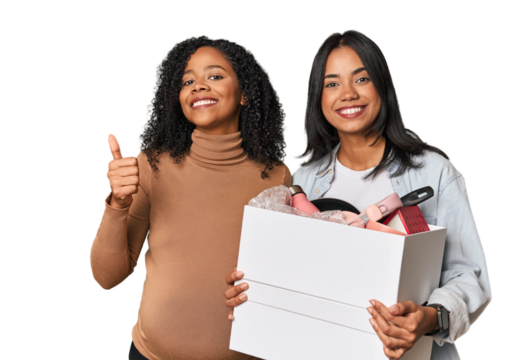 Latin women couple moving, one pregnant  smiling and raising thumb up