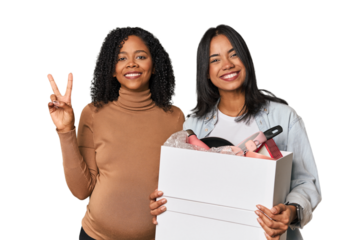 Latin women couple moving, one pregnant  showing number two with fingers.