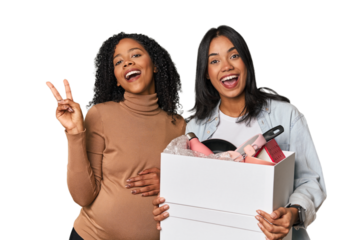 Latin women couple moving, one pregnant  joyful and carefree showing a peace symbol with fingers.