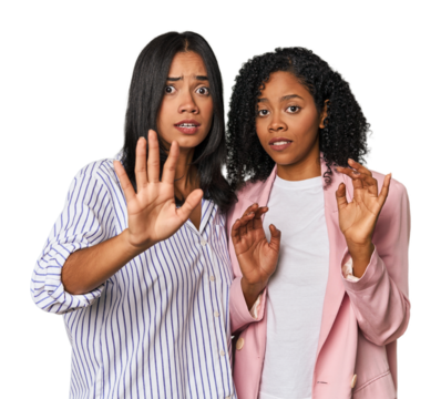 Young Latin businesswomen in studio being shocked due to an imminent danger