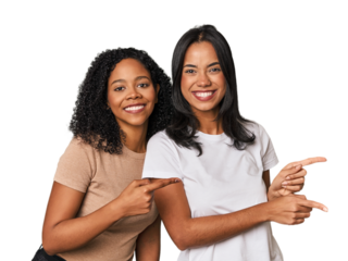 Young Latin friends in studio excited pointing with forefingers away.