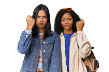 Latin friends ready for vacation showing fist to camera, aggressive facial expression.
