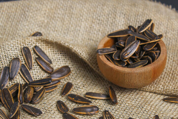 pile of sunflower seeds in a wooden bowl