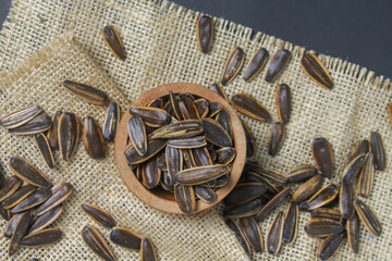 pile of sunflower seeds in a wooden bowl