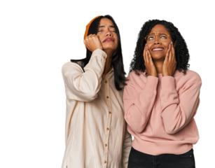 Young Latin friends together in studio crying, unhappy with something, agony and confusion concept.