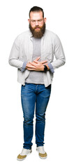 Fototapeta premium Young blond man wearing glasses with hand on stomach because indigestion, painful illness feeling unwell. Ache concept.
