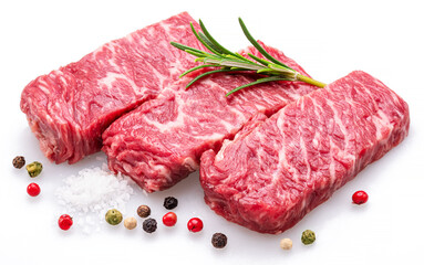 Raw pieces of beef with peppercorn and rosemary isolated on white background. Closeup.