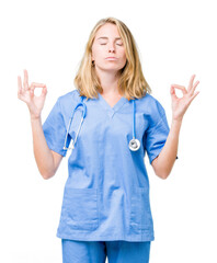 Beautiful young doctor woman wearing medical uniform over isolated background relax and smiling with eyes closed doing meditation gesture with fingers. Yoga concept.