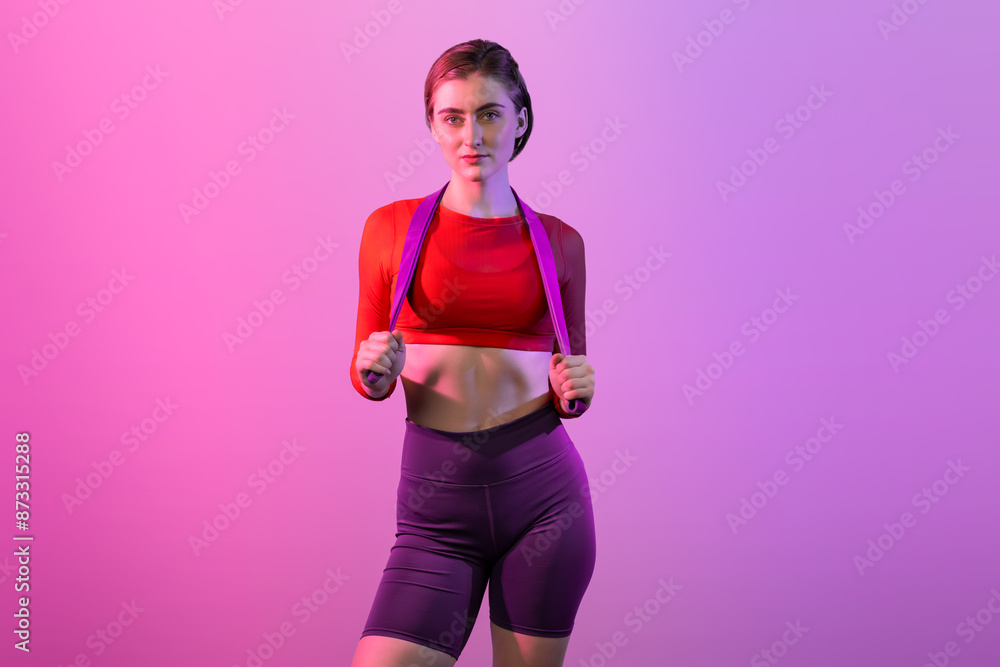 Wall mural Full body length gaiety shot athletic and sporty young woman with fitness elastic resistance band in standing posture on isolated background. Healthy active and body care lifestyle.