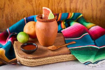 Refreshing cantaritos with tequila and lime, cocktail from mexico in a mug clay