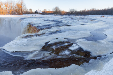 Partially frozen waterfall Jagala juga, Estonia. Water falling from fractured limestone plate