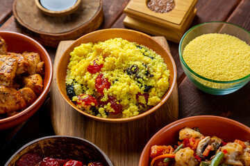 Couscous with dried fruits, chicken in spices and vegetables stewed on the table