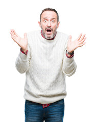Middle age hoary senior man wearing winter sweater over isolated background clueless and confused...